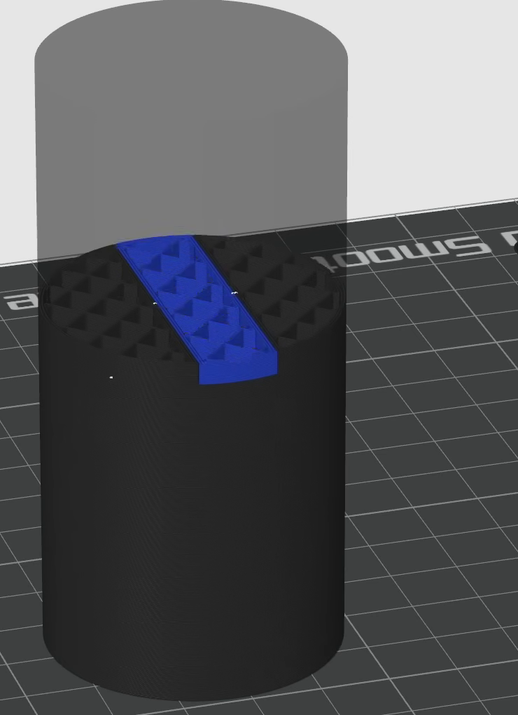 Sliced cylinder with a blue band running across it, produced by a bar shaped modifier rather than modeled geometry