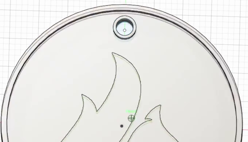 The top of the keychain showing the 3mm hanging hole surrounded by its own raised collar, inside the outer lip